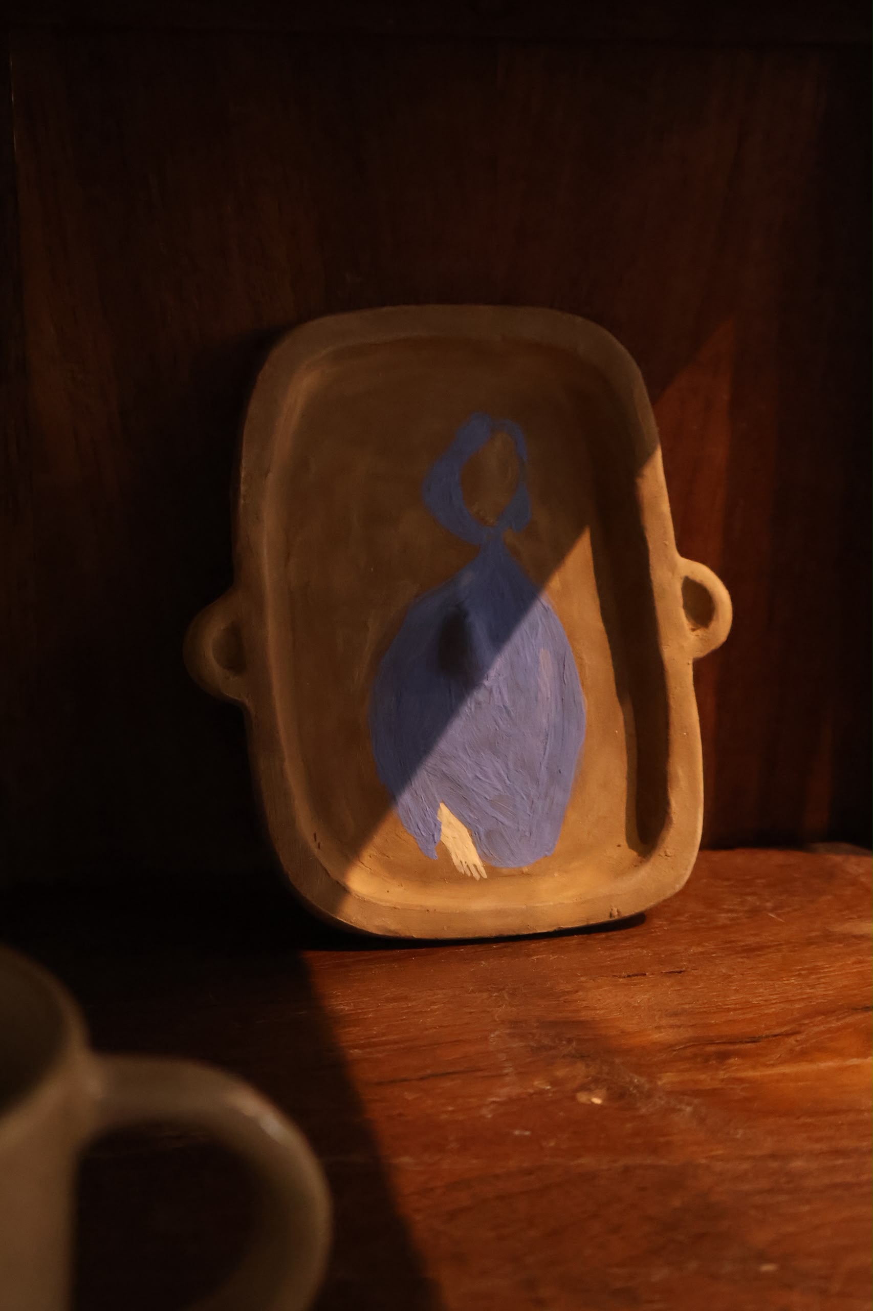 Hand shaping clay on wheel